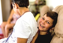 Two young Australian Aboriginal boys messing about together at home